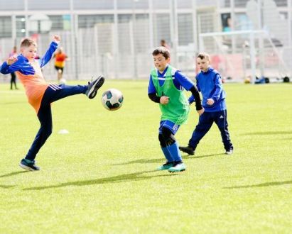An image of children playing football An image of children playing football