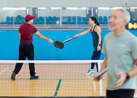 people playing pickleball smiling