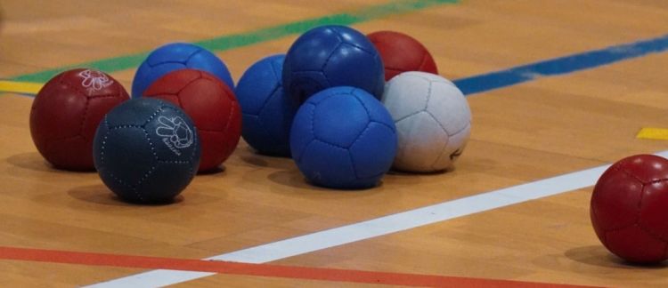 image shows boccia balls in red, blue and white