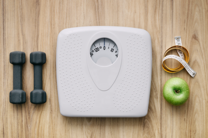 weight.PNG A scale, weights and apple