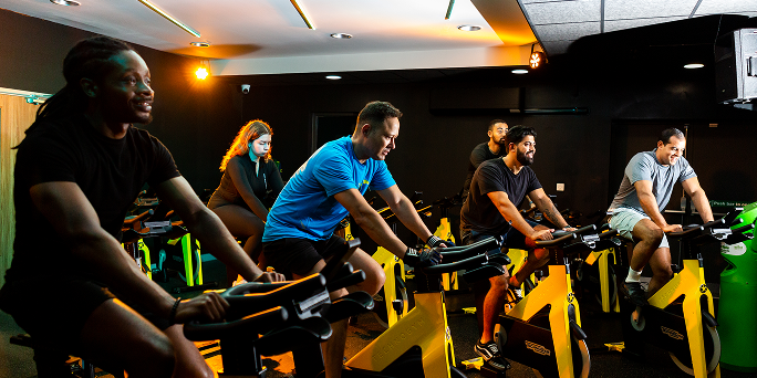 A group of people taking part in a Group Cycle class A group of people taking part in a Group Cycle class