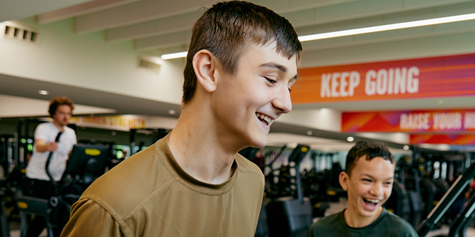 Two teenage boys working out the gym together