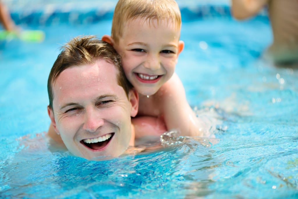Father and SOn enjoying swimming together