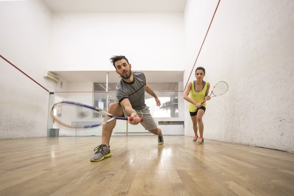 Friends playing squash together