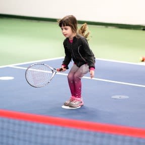 Little girl playing tennis