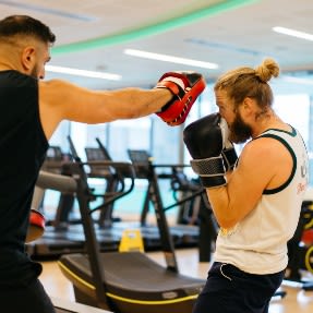 Two people boxing in a gym