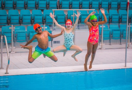 kids jumping into a pool