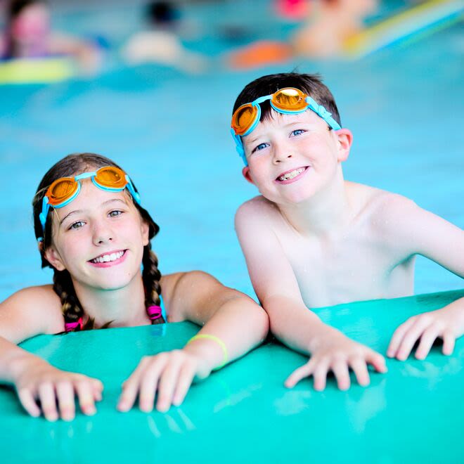 Siblings swimming. 