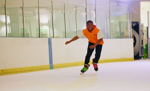 Male ice skating in an indoor ice rink