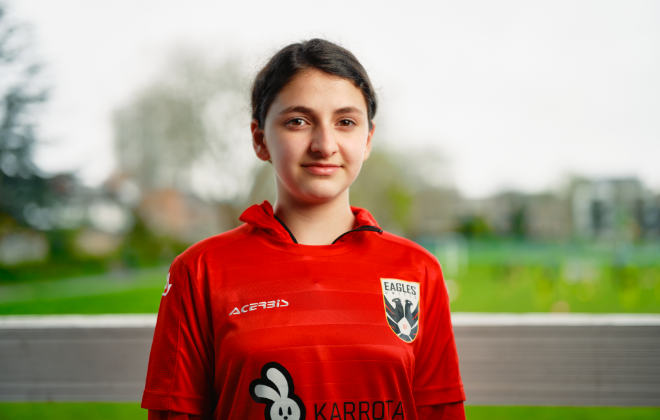 A girl wearing a red football top