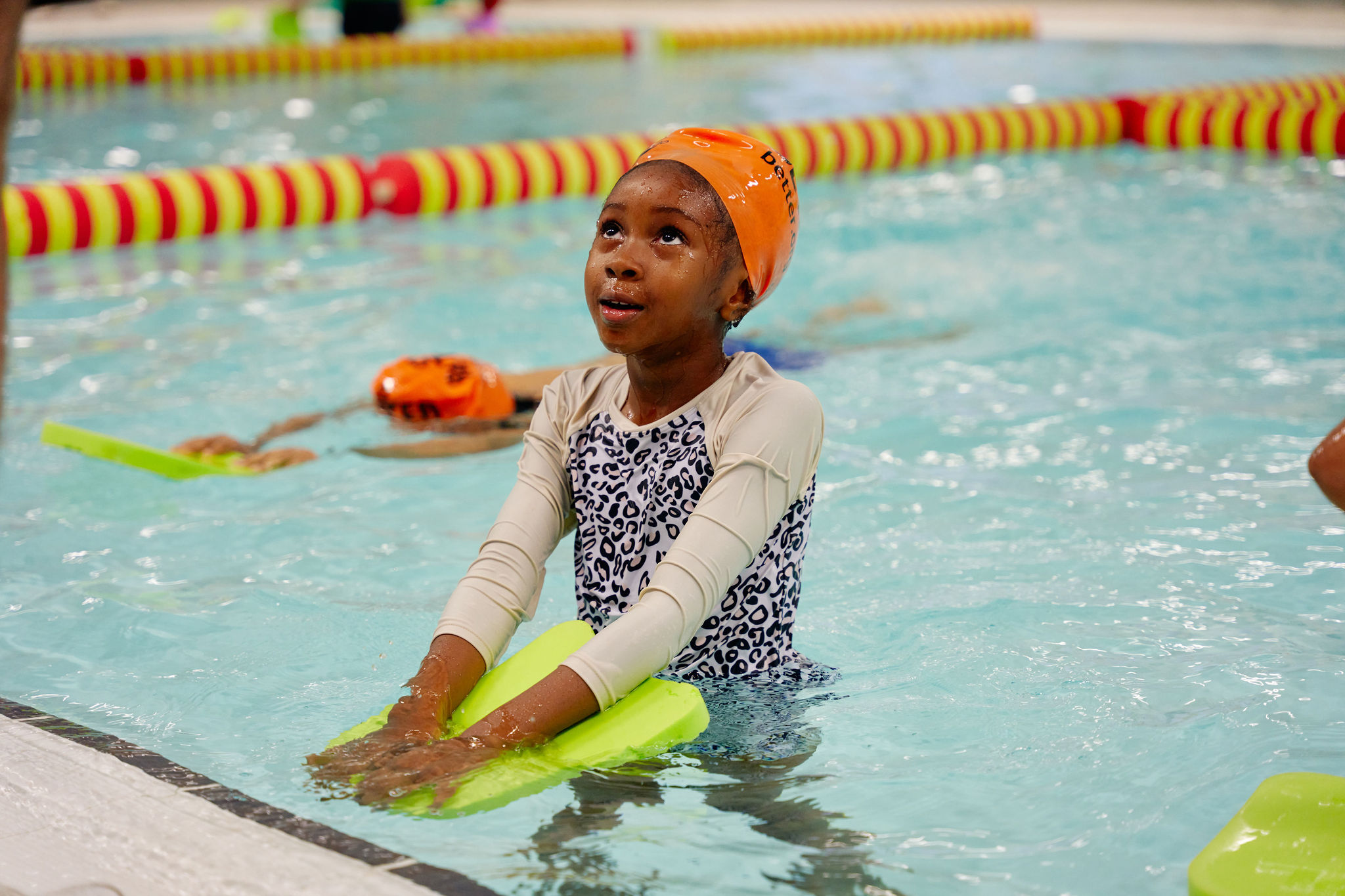 girl in water wearing amber Better branded swimming cap