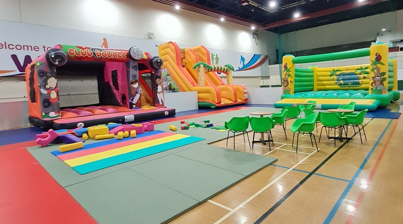 An image of two of the bouncy castles, the large slide, the soft play area, as well as parent/guardian seating. An image of two of the bouncy castles, the large slide, the soft play area, as well as parent/guardian seating.