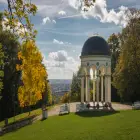 A rotunda in a park overlooking a hill