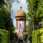 Rotunda with a Statue in it in a Formal Garden