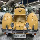 Old Fashioned Pale Yellow Car in a Technology Museum
