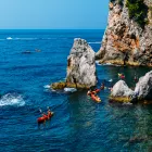 People Sea Kayaking off the Rocky Coast of Dubrovnik  