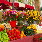Aix-en-Provence market stall filled with sunflowers, wildflowers, peppers, zucchini, and onion