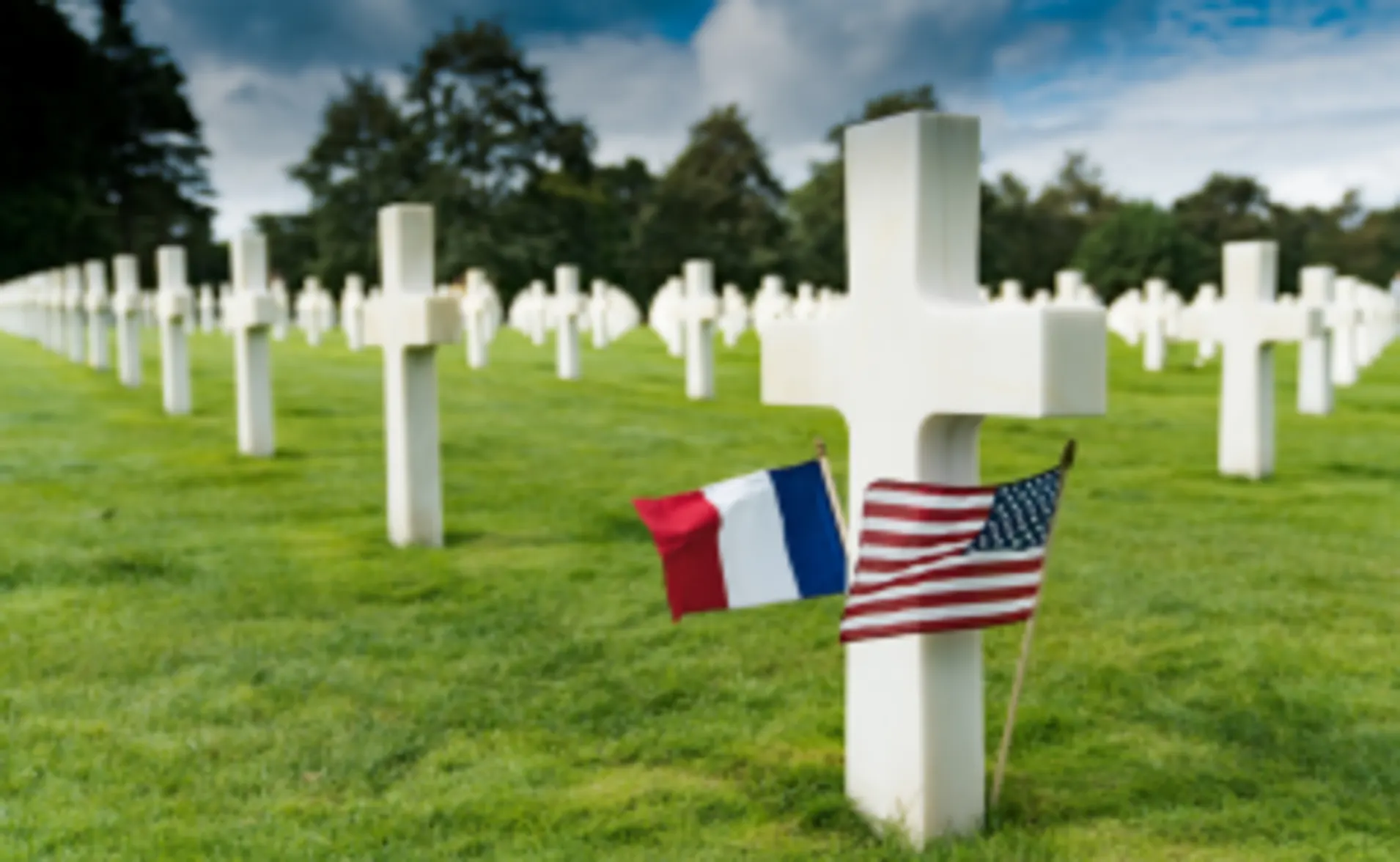 A cemetery with American and French flags
