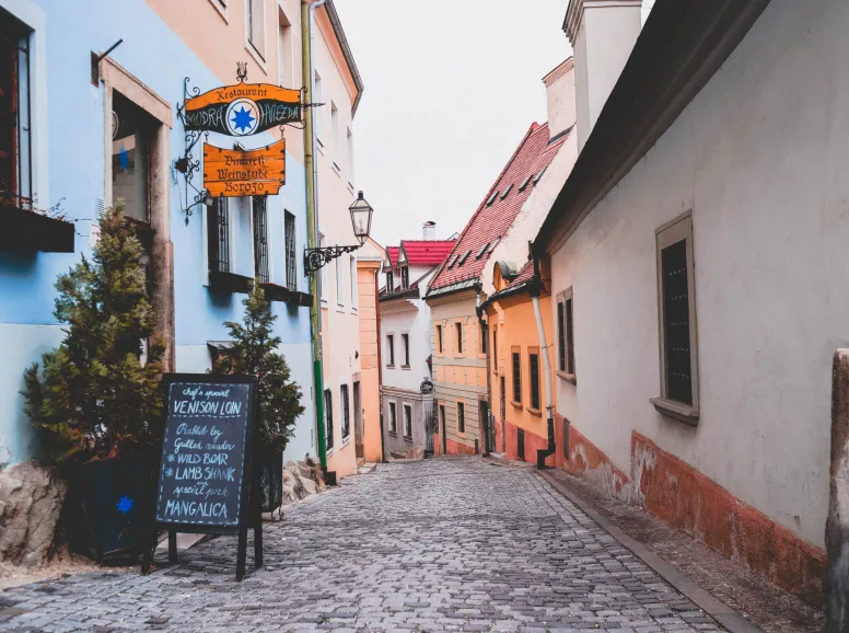 A Cobbled Street with Old Fashioned Signs in Bratislava
