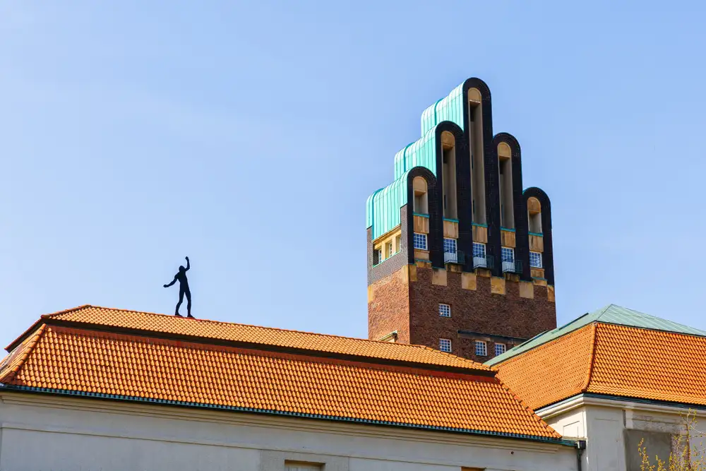 A sculpture on an orange tiled rooftop in Darmstadt 