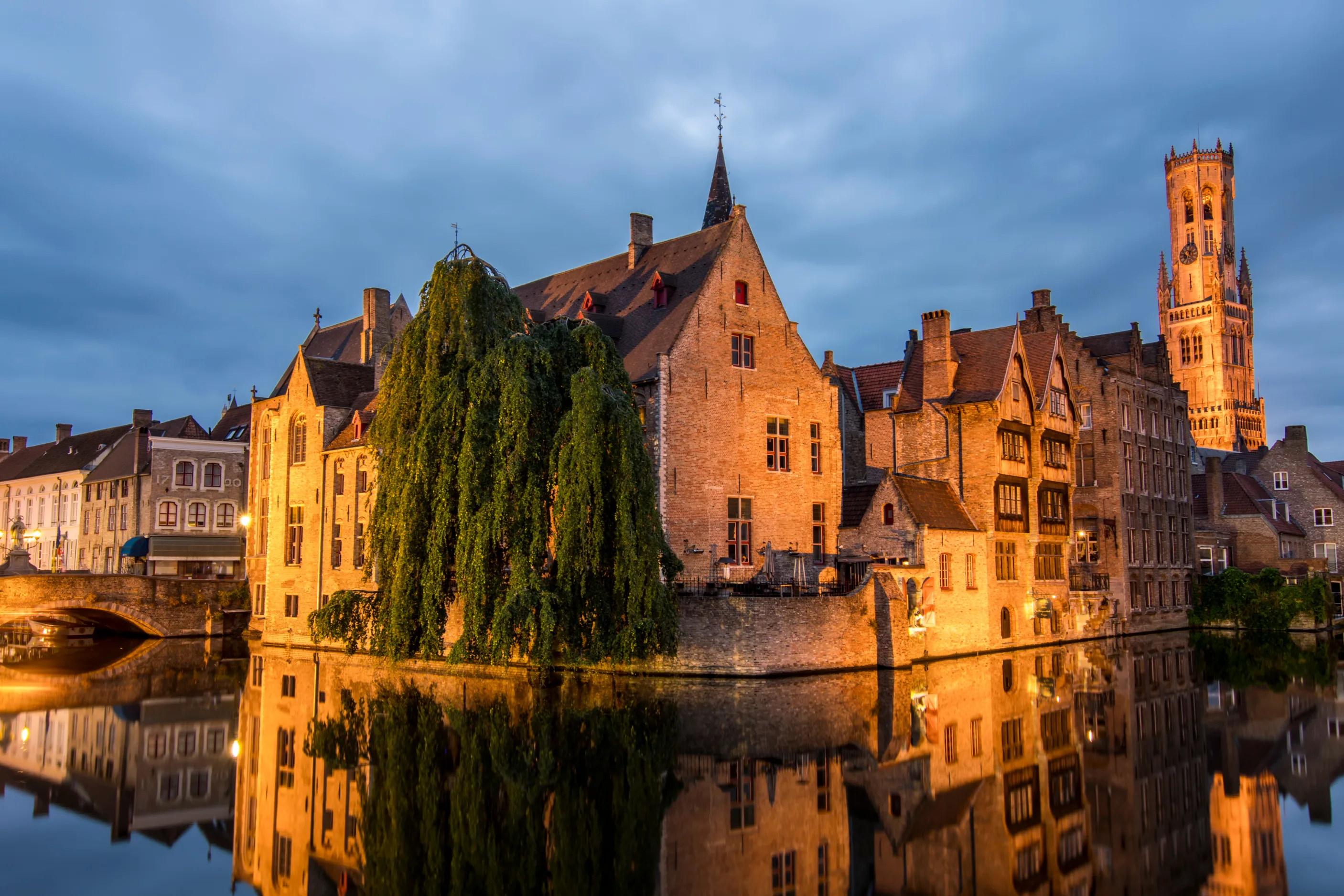A Group of Brick Medieval Houses Reflected in a Canal at Night
