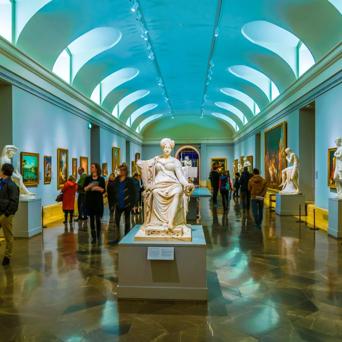 A corridor in the Prado with a statue in the middle