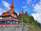 Red Trimmed Building with Swiss Flag at Harder Kulm Viewing Platform