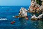 People Sea Kayaking off the Rocky Coast of Dubrovnik  