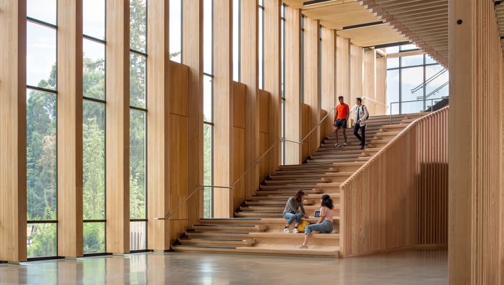 Stair case view of four people inside the Oregon forest science complex