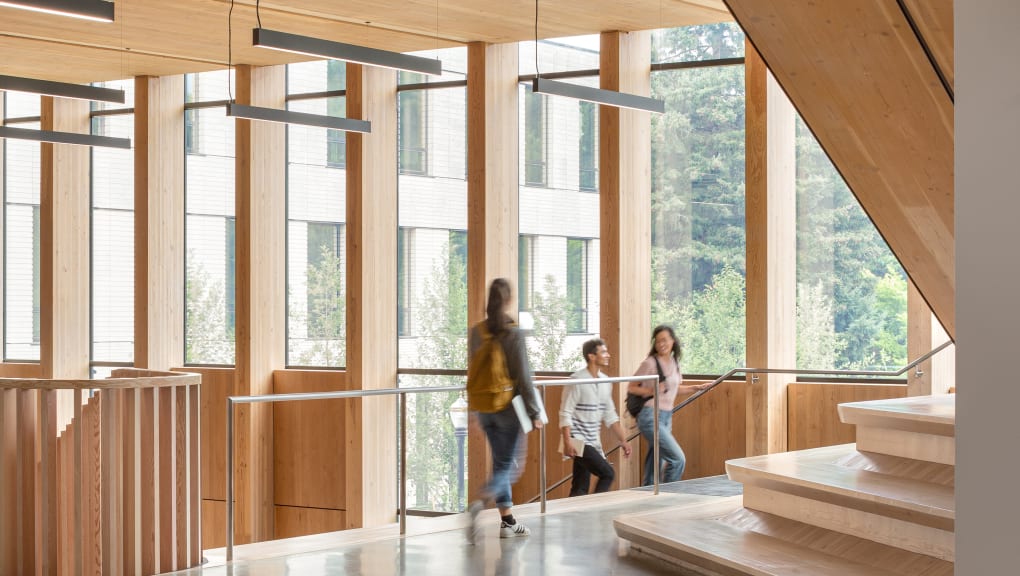 Interior view of three people standing inside the Oregon forest science complex