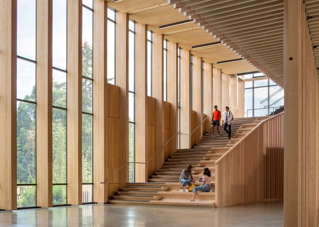 Stair case view of four people inside the Oregon forest science complex