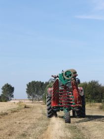 Packers - Kverneland Packomat compact and transported above ground level, dragged by tractor in a folded shape