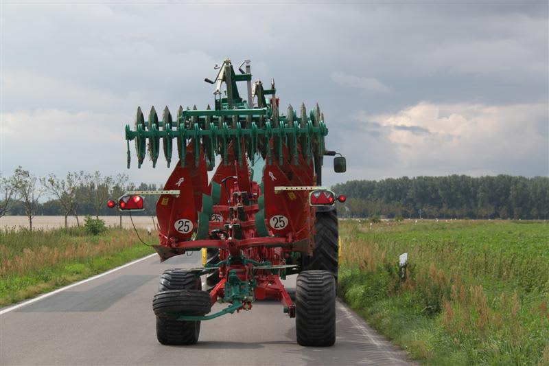 Packers - Kverneland-Packomat folded on road behind tractor