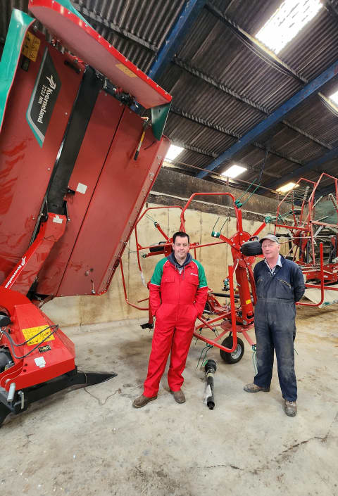 James Robbie Morrison and his father standing in front of their Kverneland Forage Equipment