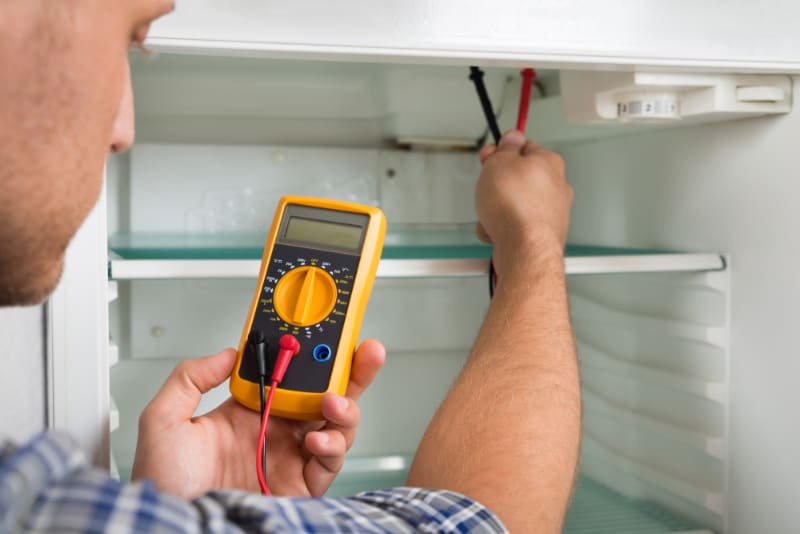 an electrician using a multimeter