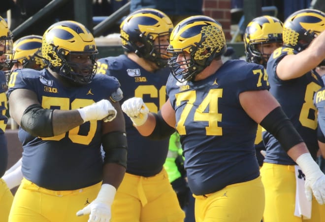 Michigan Wolverines football's Mike Onwenu (left) and Ben Bredeson