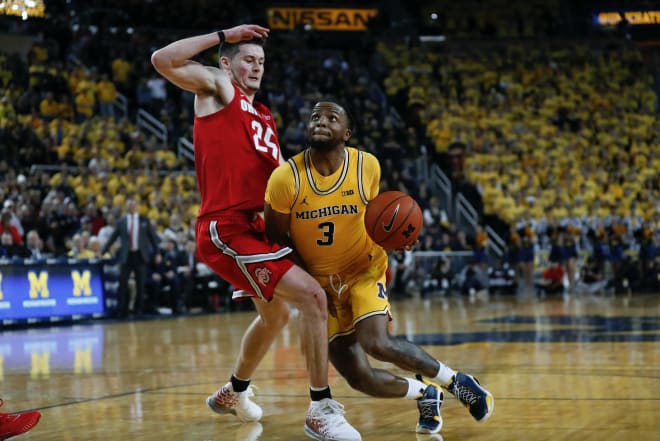 Michigan Wolverines basketball senior guard Zavier Simpson gets fouled.