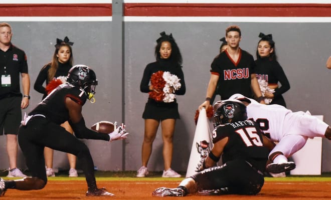 NC State Wolfpack football cornerback Chris Ingram makes an interception.