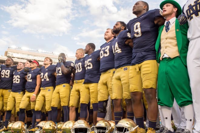 Notre Dame players singing the alma mater after a game