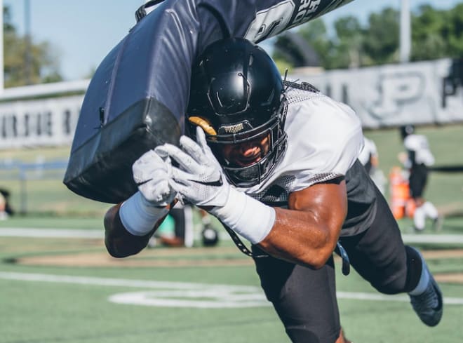 Purdue football player dives at pad