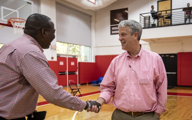 North Carolina State Wolfpack athletics director Boo Corrigan shakes a fan's hand. 