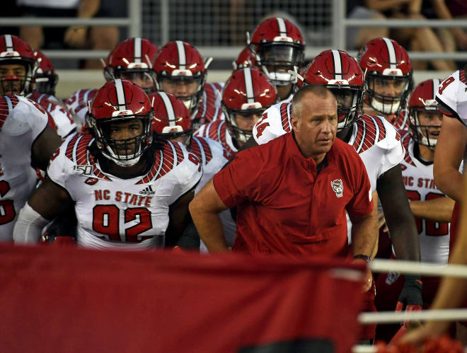 NC State Wolfpack football coach Dave Doeren and the Pack take the field.