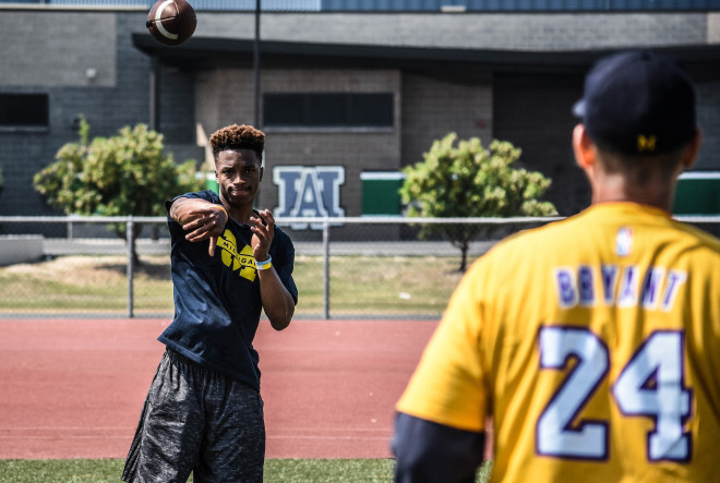 Thompson-Robinson warms up with Harbaugh at the Los Angeles satellite camp.