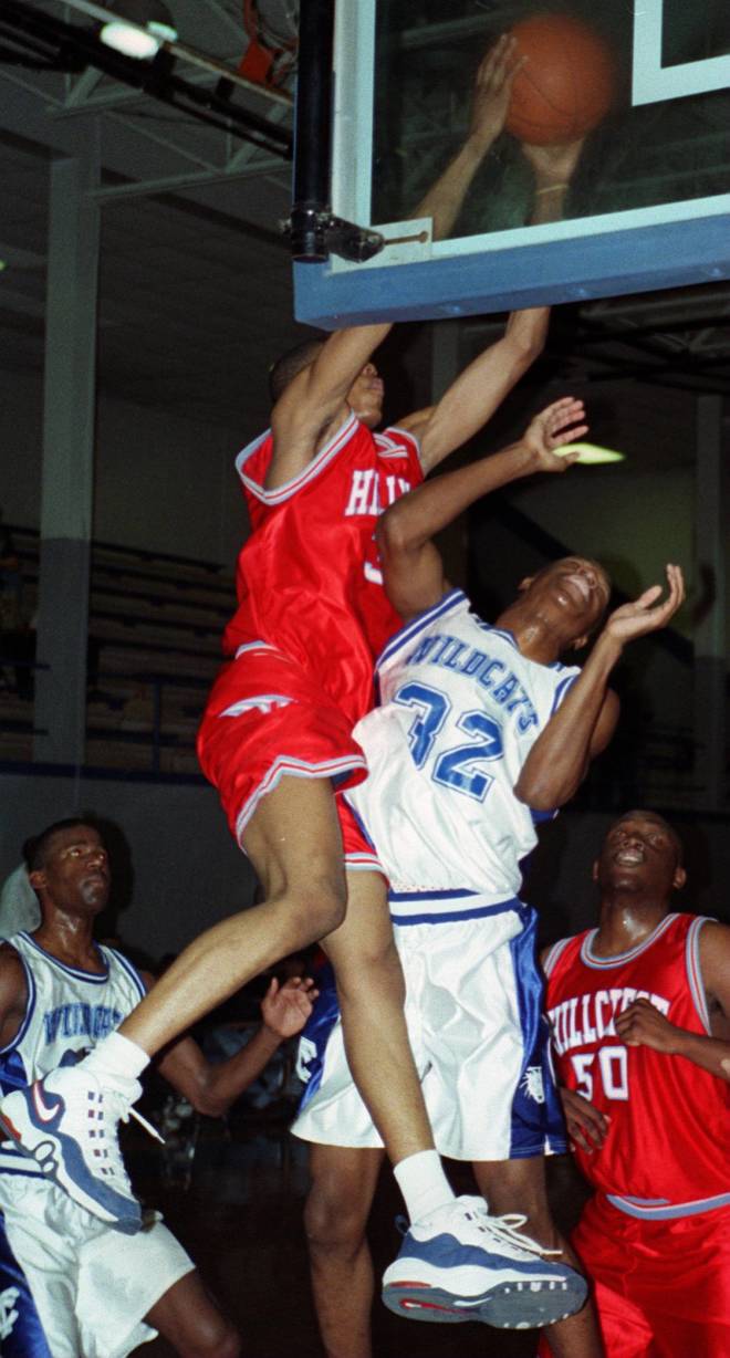 Hillcrest High School's No. 32,  Sidney Ball, dunks over TCHS' No. 32, Claude Davis, in February 1998. Ball was a star at Hillcrest, finishing in 1999 and earning a Division I scholarship.