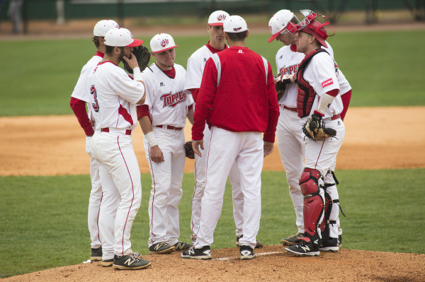 WKU players and head coach John Pawlowski meet at the mound at Nick Denes Field.