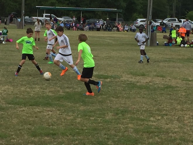 Oxford's Carson McCready (white jersey, orange shoes) works against two defenders from Jackson in the President's Cup (U9 division) state tournament in Columbus Sunday. Jackson won, something to 1, though McCready scored the 1, his fourth goal of the tournament. For those of you wanting bias, there's some serious freaking bias.