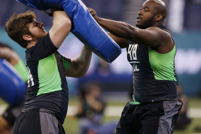 Joe Thuney (left) works at the NFL Combine.