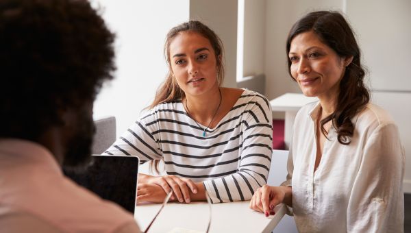 mother and daughter talking to doctor