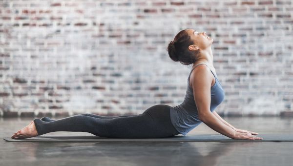 woman doing yoga pose, cobra