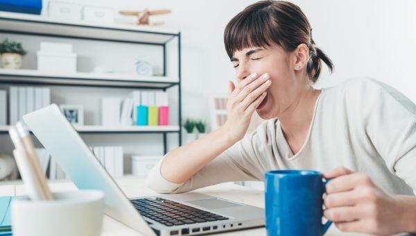 woman yawning at desk